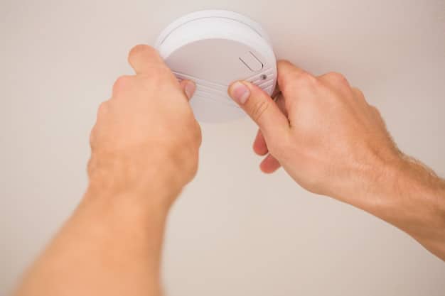 Handman installing smoke detector