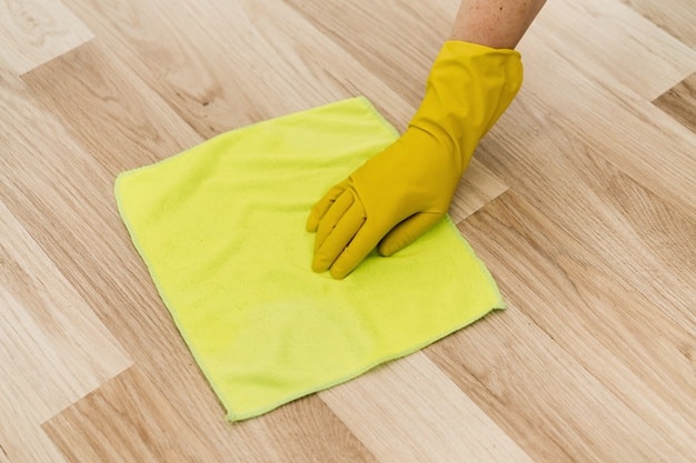 Woman with rag cleaning the floor