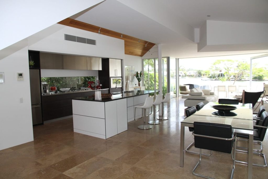 Modern designed open plan kitchen with bar and stainless steel fridge