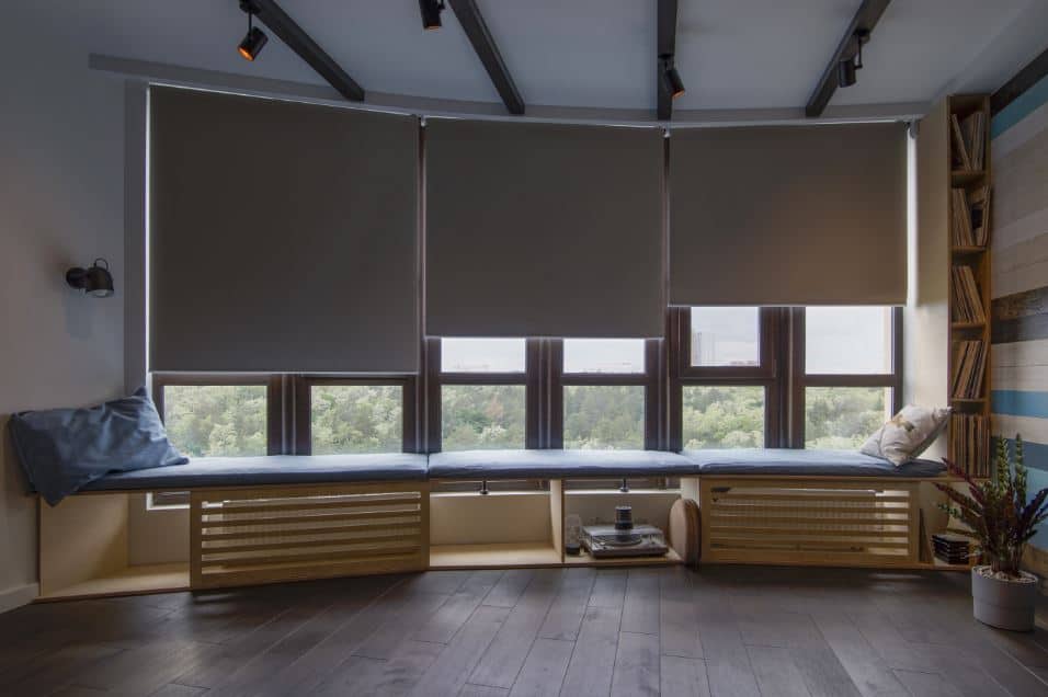 Roller blinds half way down a window in a home study