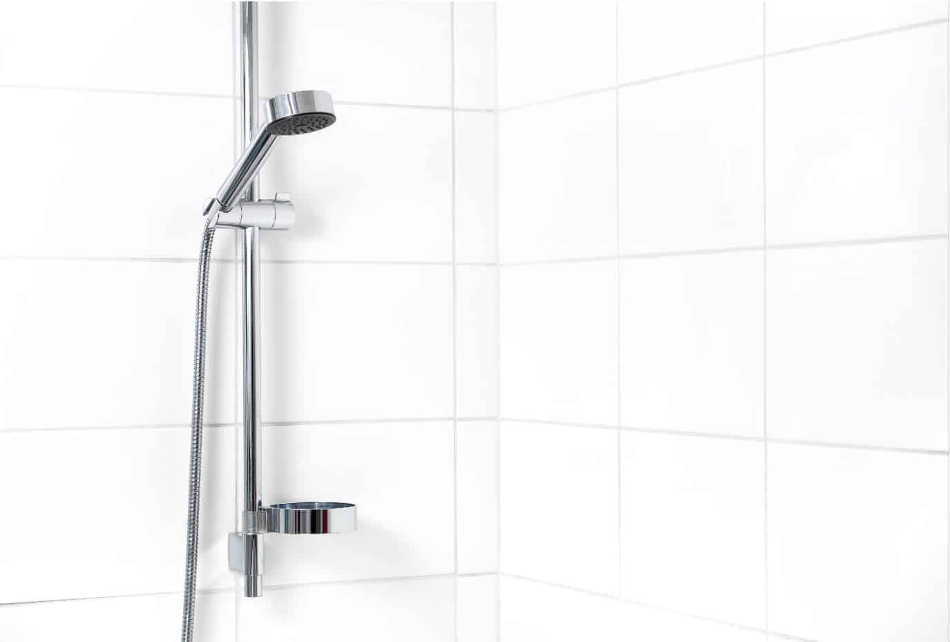 Modern shower with white wall tiles. Simple stylish Scandinavian home interior design.