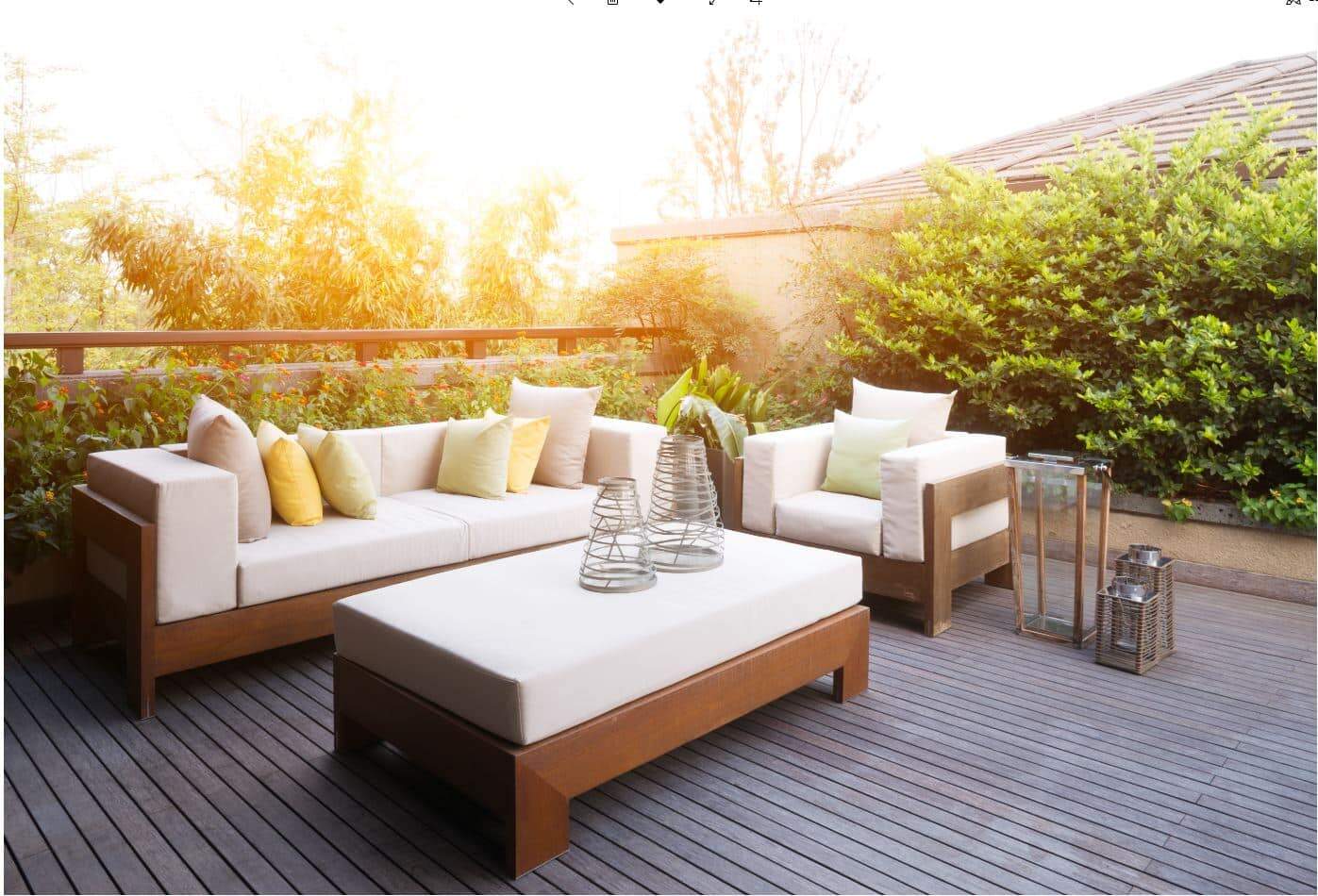 a two seater outdoor couch next to a single seater outdoor sofa and coffee table
