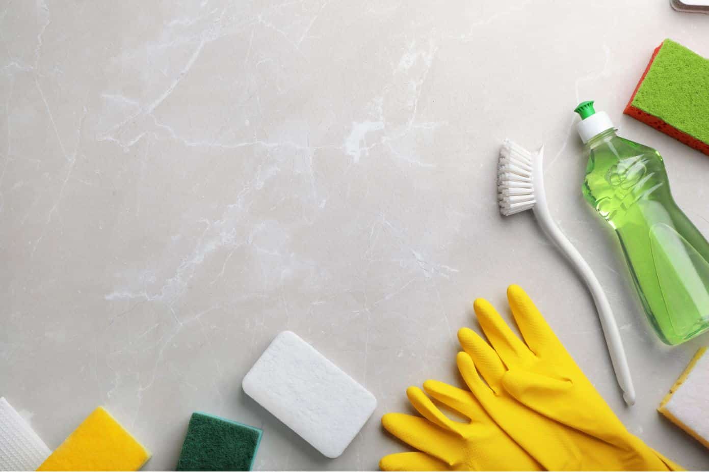 dishwashing liquid and cleaning utensils on a benchtop