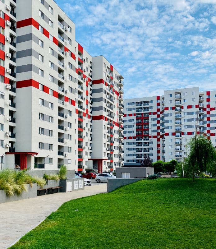 large shared apartment complex with playground in the middle