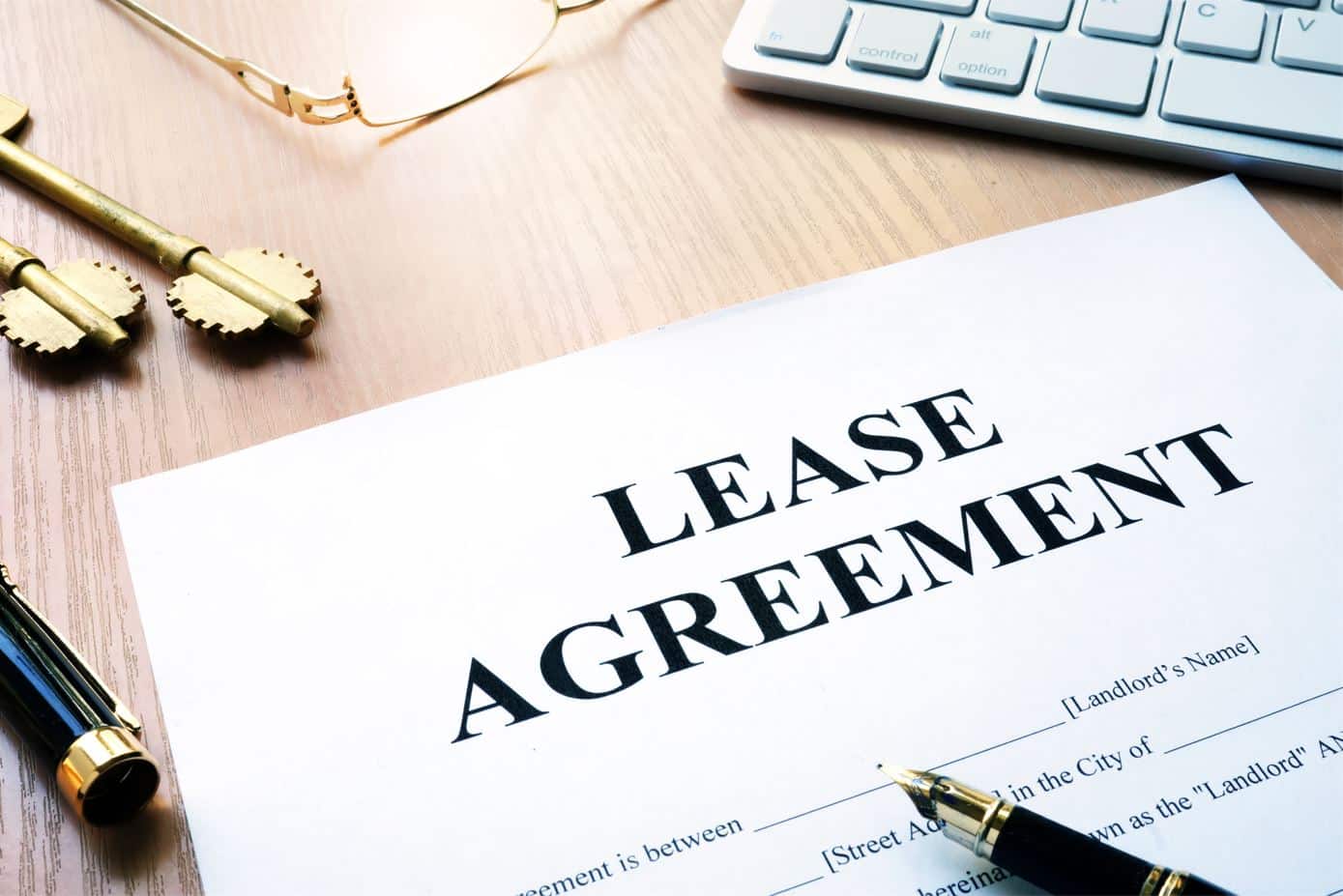 rental lease agreement form on a desk next to a chrome coloured keyboard