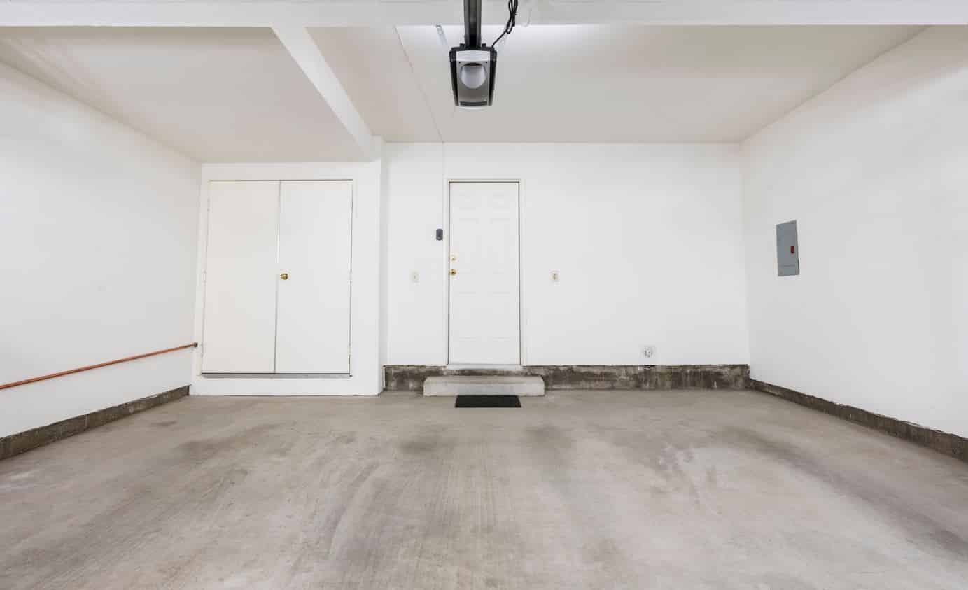 large opened space garge with a dirty concrete floor