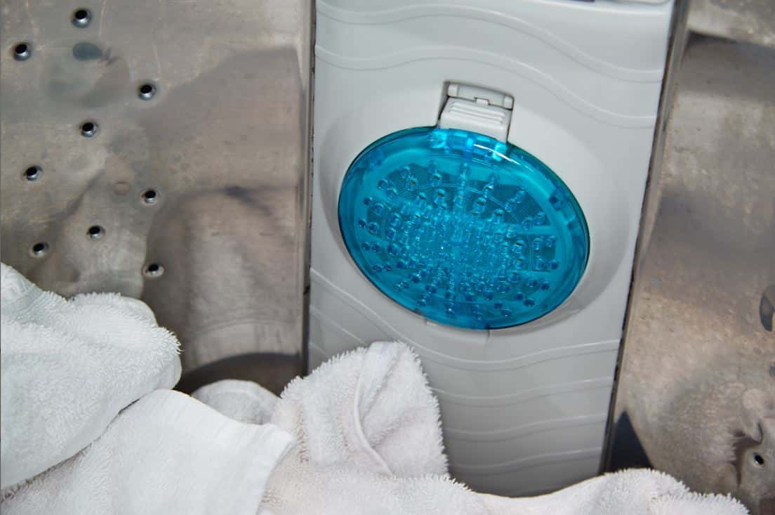 blue washing machine filter in stainless steel washing machine drum