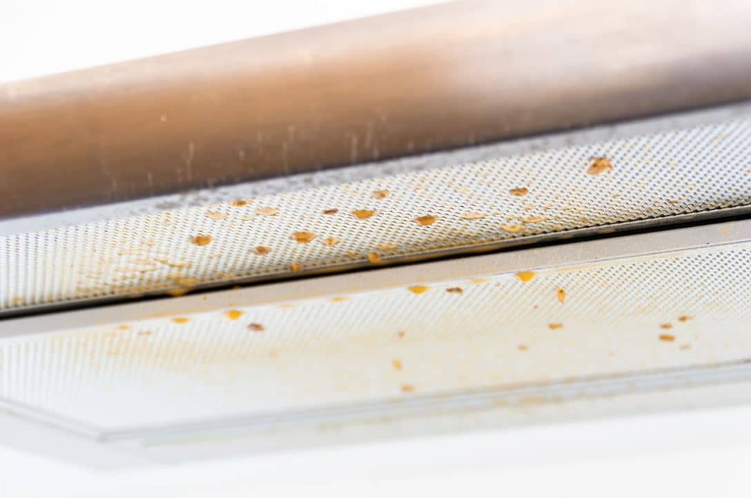 close up of grease dropping from a dirty rangehood filter